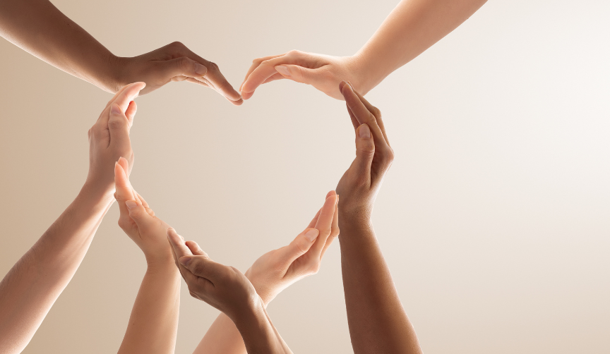 Hands from many people forming a heart to symbolize caring and helping others